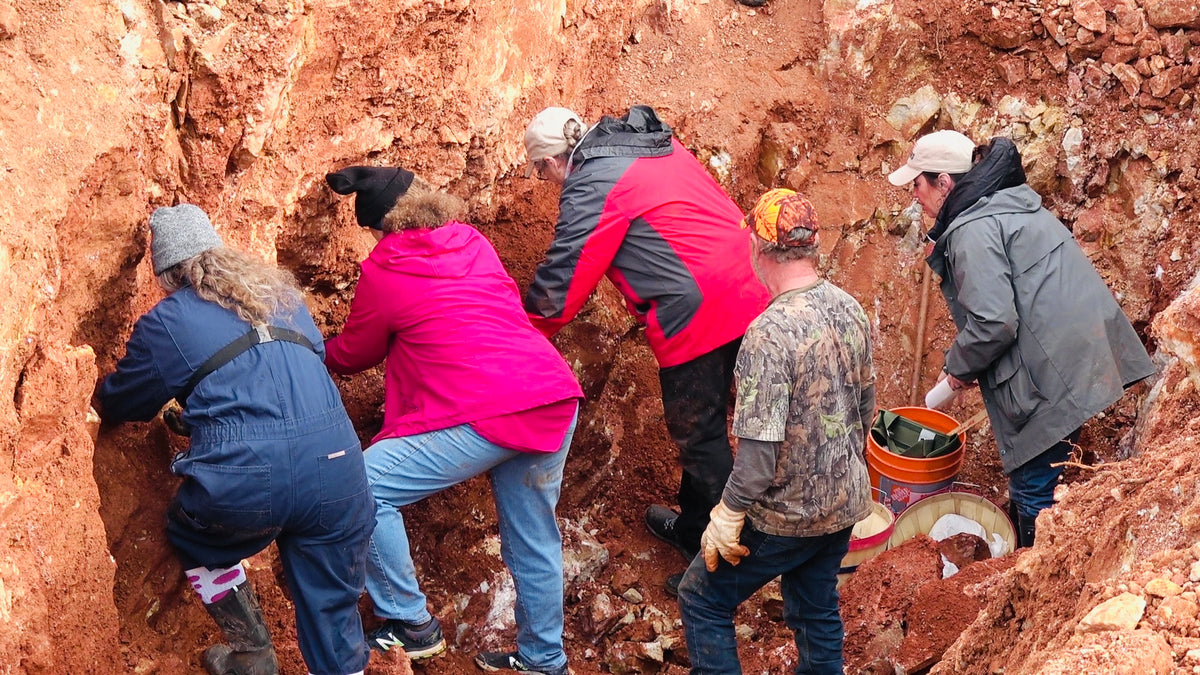 people mining quartz crystals in private pocket dig located at Zigras mine with Avant Mining located in Central Arkansas.
